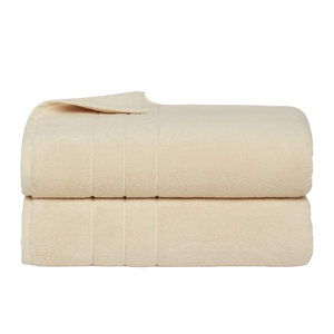 A folded, cream-colored blanket with subtle horizontal stitching details, presented as a neatly stacked pair.