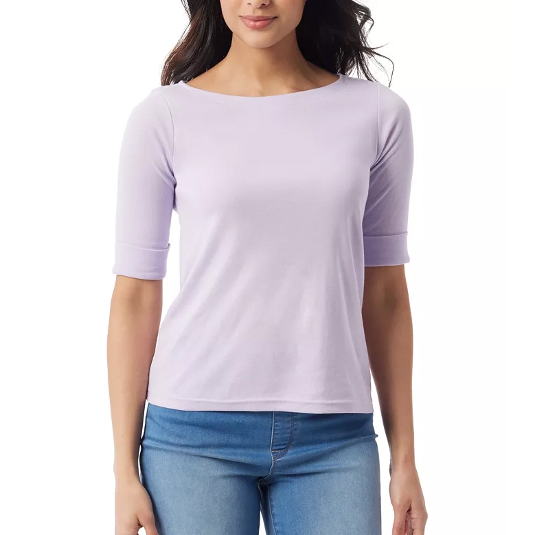 A woman wearing a light purple, elbow-sleeve top with a boat neckline paired with blue jeans.