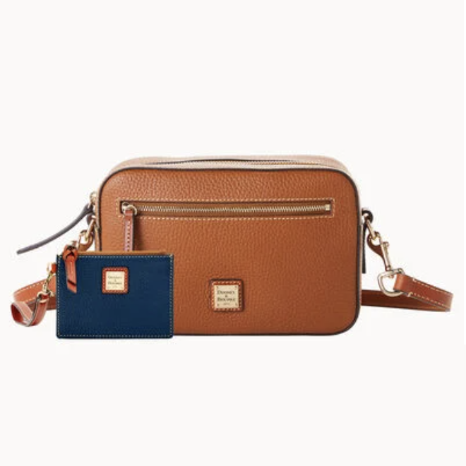 A brown leather crossbody bag with a front zipper and a blue cardholder, both bearing gold-toned brand plaques.