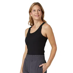 A person is wearing a black sleeveless tank top and gray pants with an elastic waistband, standing with one hand in a pocket.