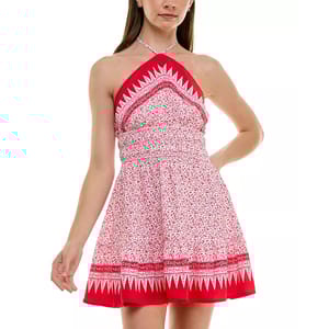 Sleeveless red-and-white halter dress featuring a bandana-style pattern, floral motifs, and a flared skirt with distinct geometric border details.