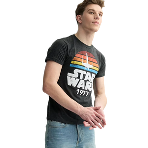 Gray tee featuring a vintage \“Star Wars 1977\“ logo with a retro-style sunset and starfighter graphic in orange, red, and blue colors.