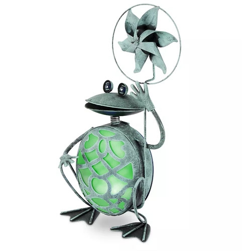 Metal frog garden sculpture with a green, stained-glass-style belly holding a pinwheel.