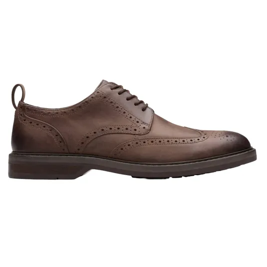 A brown leather wingtip brogue shoe with decorative perforations and a pull tab on the heel, featuring a lace-up design and a solid sole.