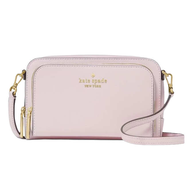 A pastel pink Kate Spade New York crossbody bag with gold-tone hardware and dual zippers, featuring an adjustable strap and logo embossed on the front.