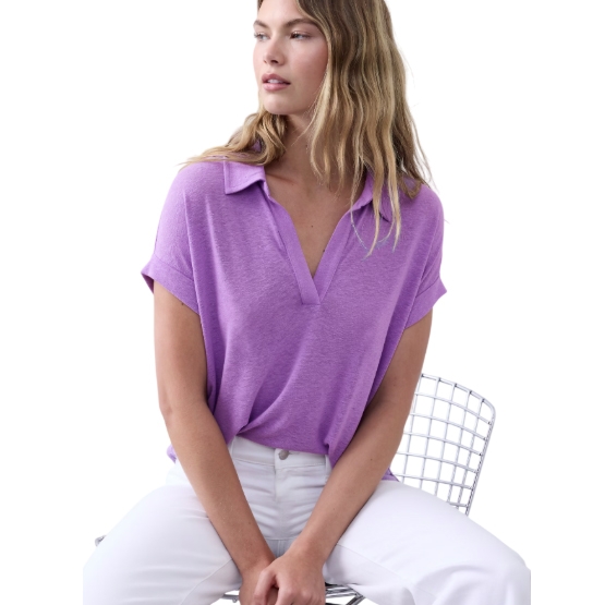 Purple short-sleeve shirt with a relaxed fit, featuring a Johnny collar and V-neck design, paired with white pants.