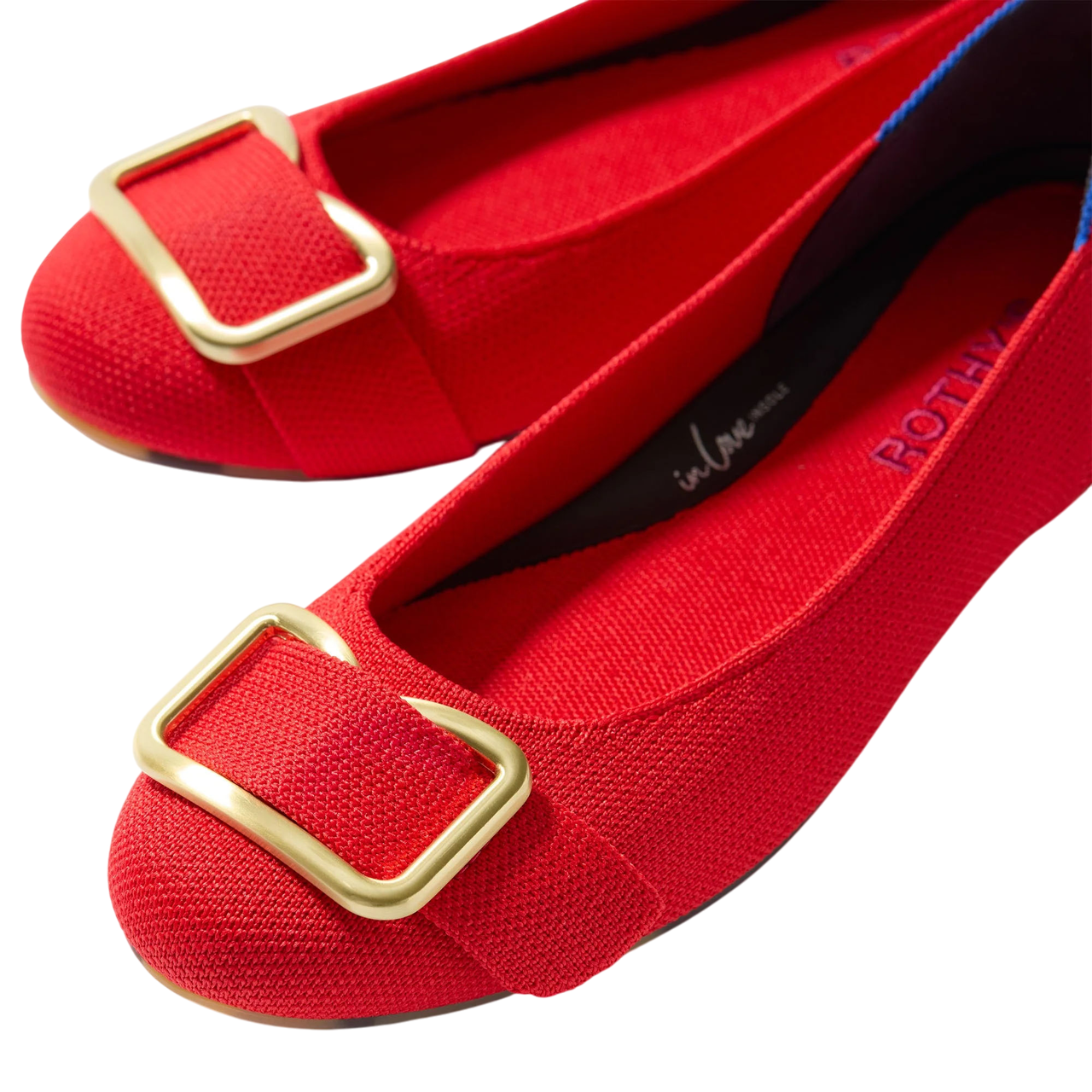 Red ballet flats with gold buckles, featuring a textured fabric and branding on the insole.