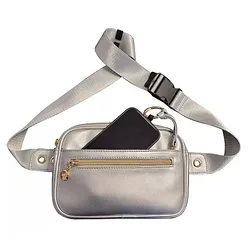 A silver fanny pack with a black buckle strap, featuring a front zippered pocket and a larger main compartment holding a black smartphone.
