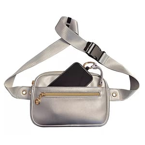 A silver fanny pack with a black buckle strap, featuring a front zippered pocket and a larger main compartment holding a black smartphone.