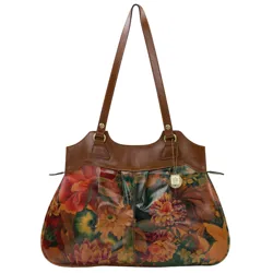 A floral-patterned handbag featuring brown leather handles and trim, with a decorative chain and charm accent.
