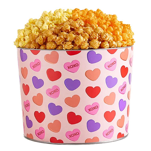 Three different types of popcorn in a pink heart-printed tin.