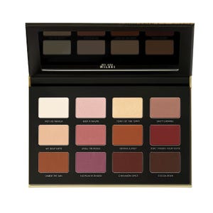 A palette of 12 matte eyeshadows in a range of neutral and warm tones, with shade names like \“Not a Basic Peach\“ and \“Suede Side to Side\“ displayed below each color.