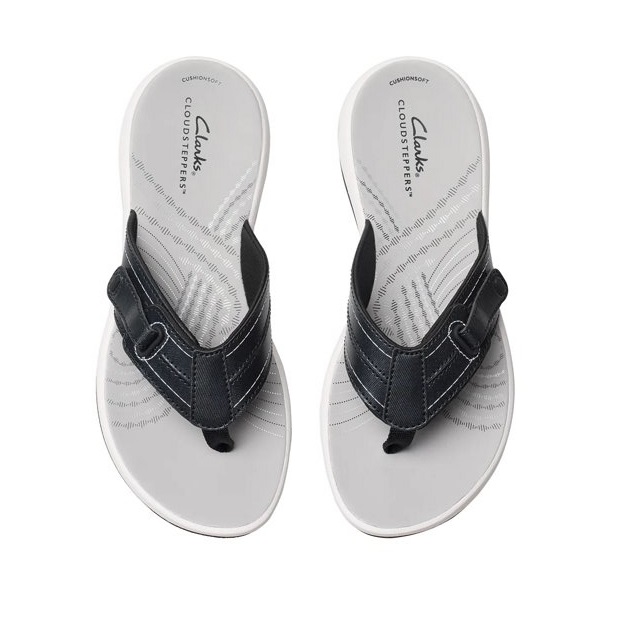 Clarks Sunmaze Loop Sandals feature black textile straps and a cushioned white footbed with textured patterns. They offer Curionsoft Cloudsteppers for comfort.
