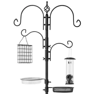 A multipurpose black metal bird feeding station with hooks for feeders, a suet cage, a water dish, and a seed tray.