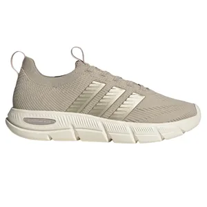 A beige Adidas sneaker with Cloudfoam Flex technology, featuring a knit upper, pull tabs, and metallic stripes on the side.