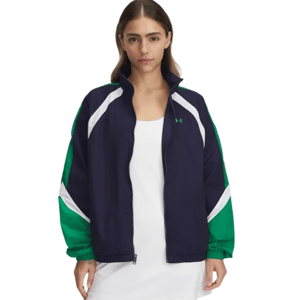 A woman is wearing a navy and green zip-up jacket with white accents from Under Armour, over a white dress.