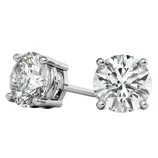 A pair of round-cut diamond stud earrings with a four-prong setting in a silver or white gold metal.
