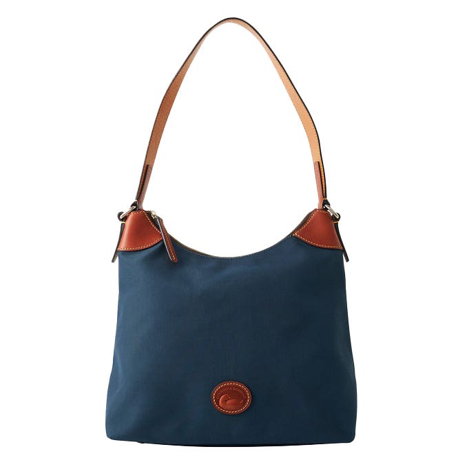 A blue shoulder bag with brown leather accents and a single strap. The bag features a circular leather logo detail on the front.