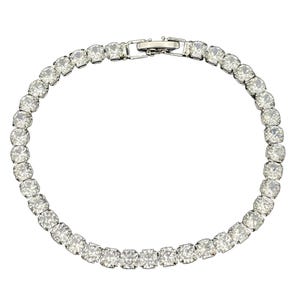 A tennis bracelet with round-cut clear stones set in a continuous line, featuring a clasp closure.