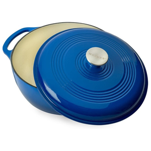 Blue cast iron round Dutch oven with a cream-colored interior and a stainless steel knob labeled \“Mercer\“ on the lid. It features a side handle for easy lifting and has a ribbed design on the lid.