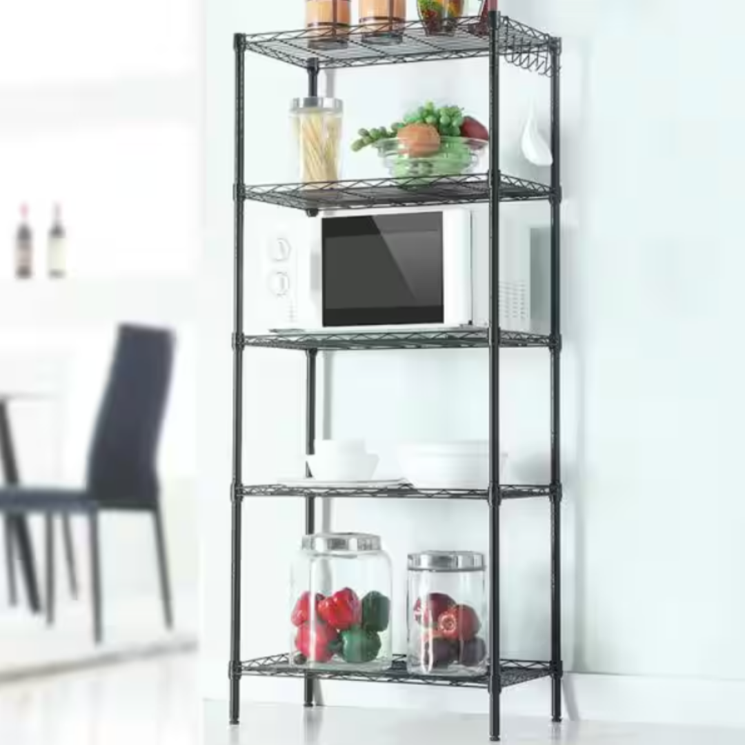 A black metal shelving unit with a microwave, pasta jar, fruits, vegetables, and two jars containing whole peppers.