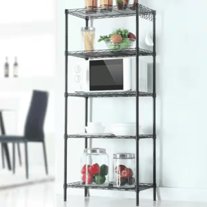 A black metal shelving unit with a microwave, pasta jar, fruits, vegetables, and two jars containing whole peppers.
