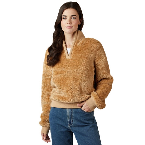A person wears a brown fleece pullover with a half-zip and ribbed cuffs and hem, paired with blue jeans.