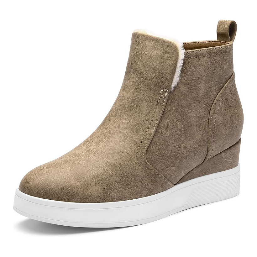 A tan ankle boot with a side zipper and white platform sole, featuring a subtle wedge heel and faux fur lining at the top.