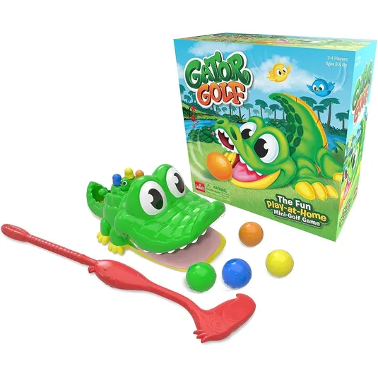 Gator Golf is a colorful children’s mini-golf game featuring a green cartoon alligator with wide eyes and a red golf club. It includes several colorful balls, designed for 2-4 players ages 3 and up.
