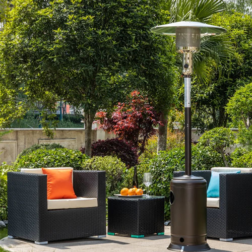a propane patio heater on a patio in front of two chairs