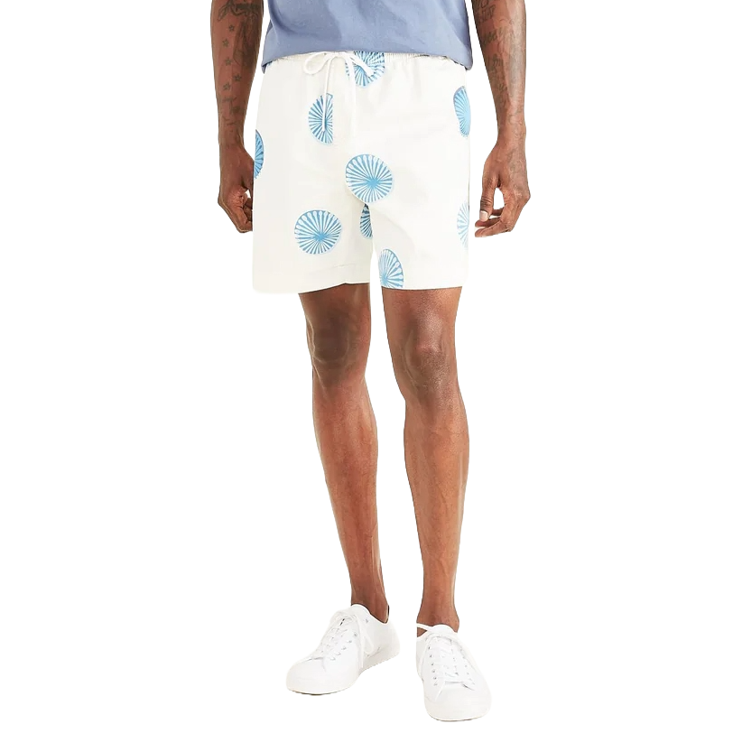 White shorts with blue circular patterns, paired with a light blue shirt and white sneakers.