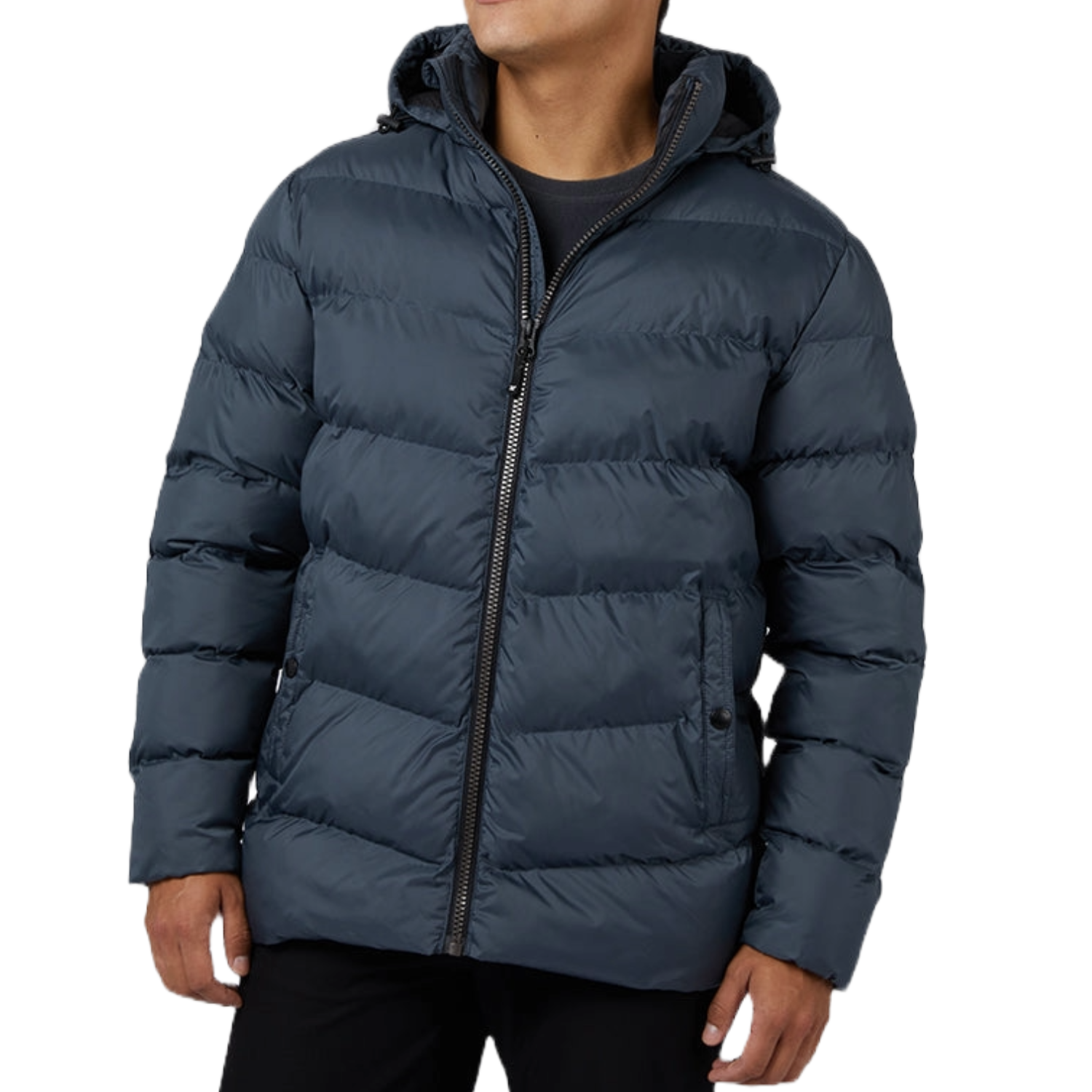 A person wears a dark blue, hooded, quilted winter jacket with a front zipper and side pockets, paired with black pants.