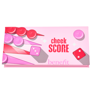 Pink packaging features the words \“cheek SCORE\“ and the brand name \“Benefit\“ alongside game token imagery, likely indicating a makeup palette for cheeks.