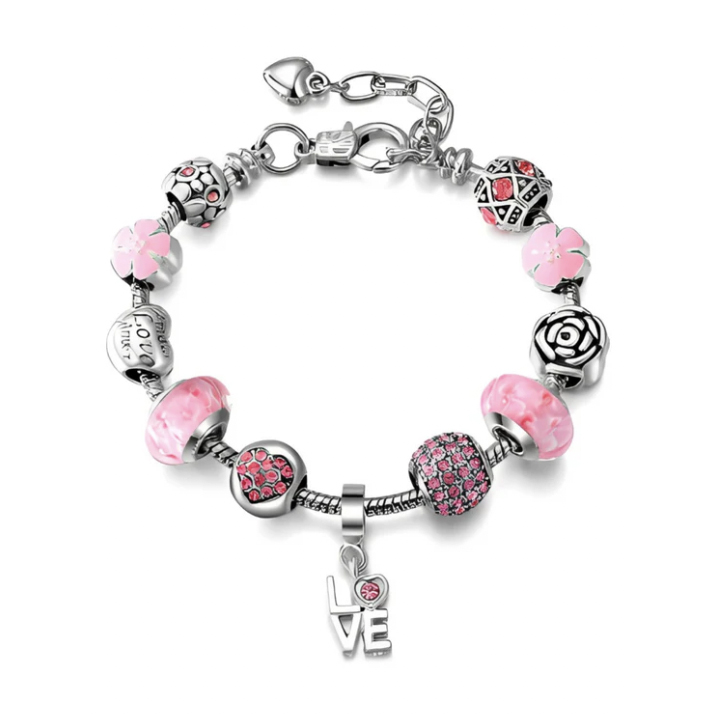 A silver charm bracelet featuring pink and silver beads and charms, including hearts, flowers, and the word \“LOVE\“ with a small pink stone. It has a lobster clasp and an adjustable chain for sizing.
