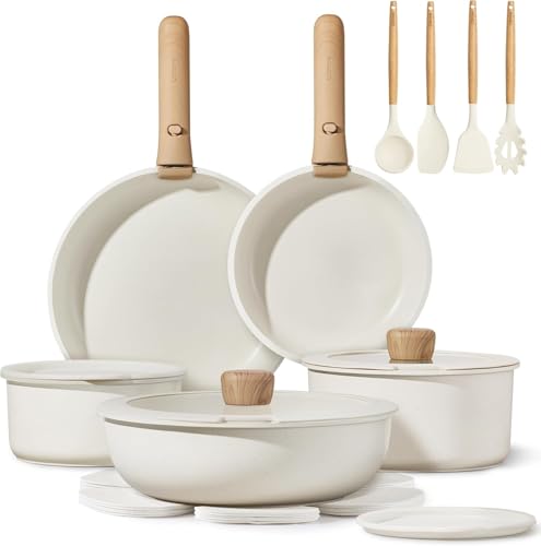 A collection of white cookware and kitchen utensils with wooden handles, including frying pans, saucepans with lids, and cooking tools like a spatula, ladle, and pasta server.