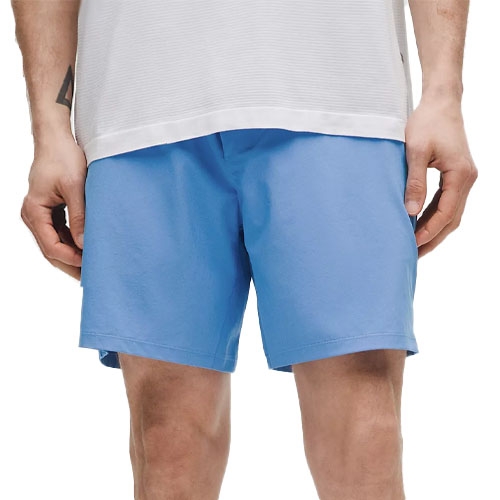 A person is wearing light blue shorts paired with a white shirt.