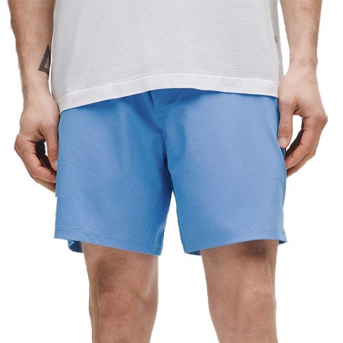 A person is wearing light blue shorts paired with a white shirt.