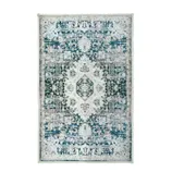 A rectangular area rug with an intricate, symmetrical floral and geometric pattern in shades of blue, grey, and white.