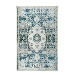 A rectangular area rug with an intricate, symmetrical floral and geometric pattern in shades of blue, grey, and white.