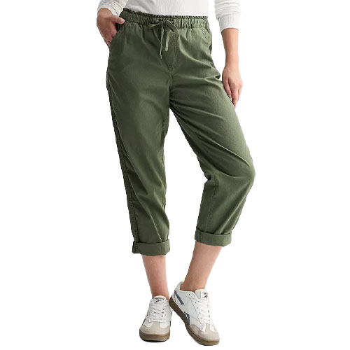 A person wears olive green cropped jogger pants with an elastic waistband, paired with white sneakers.