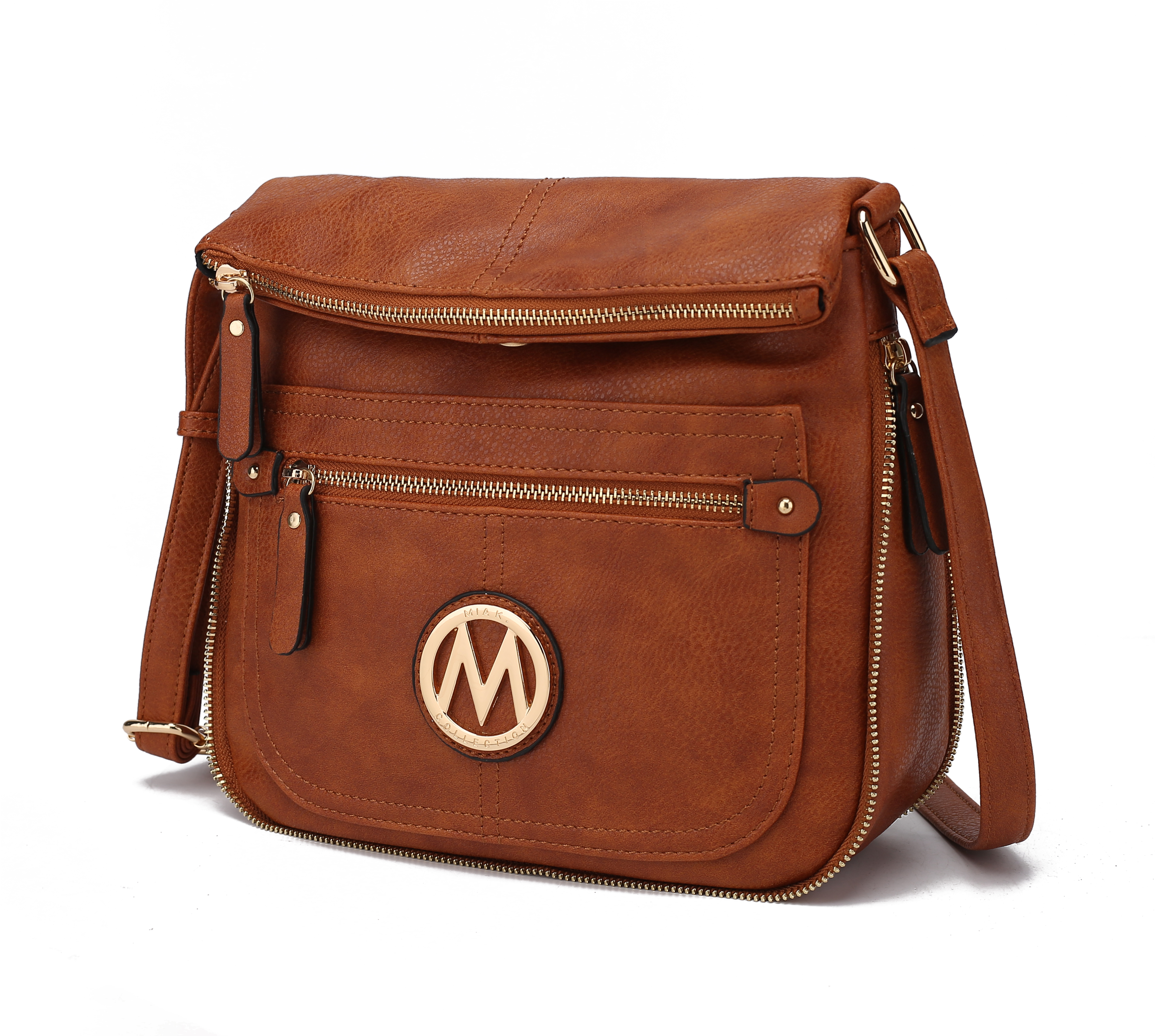A brown leather crossbody bag featuring multiple zippered compartments and a decorative circular emblem with an \“M\“ on the front.