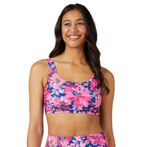 A sleeveless bikini top with wide straps, featuring a vibrant pink and navy blue floral pattern.