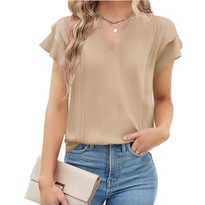 A woman wears a beige V-neck blouse with short ruffled sleeves, paired with blue jeans and holding a light beige clutch. A layered necklace adds a touch of elegance.