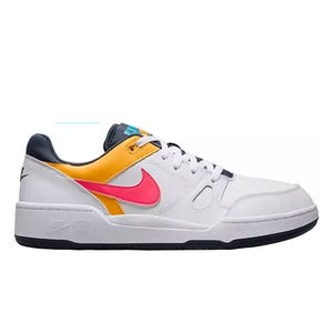 A white sneaker with a black sole features a colorful design with a bright pink Nike swoosh and orange accents.