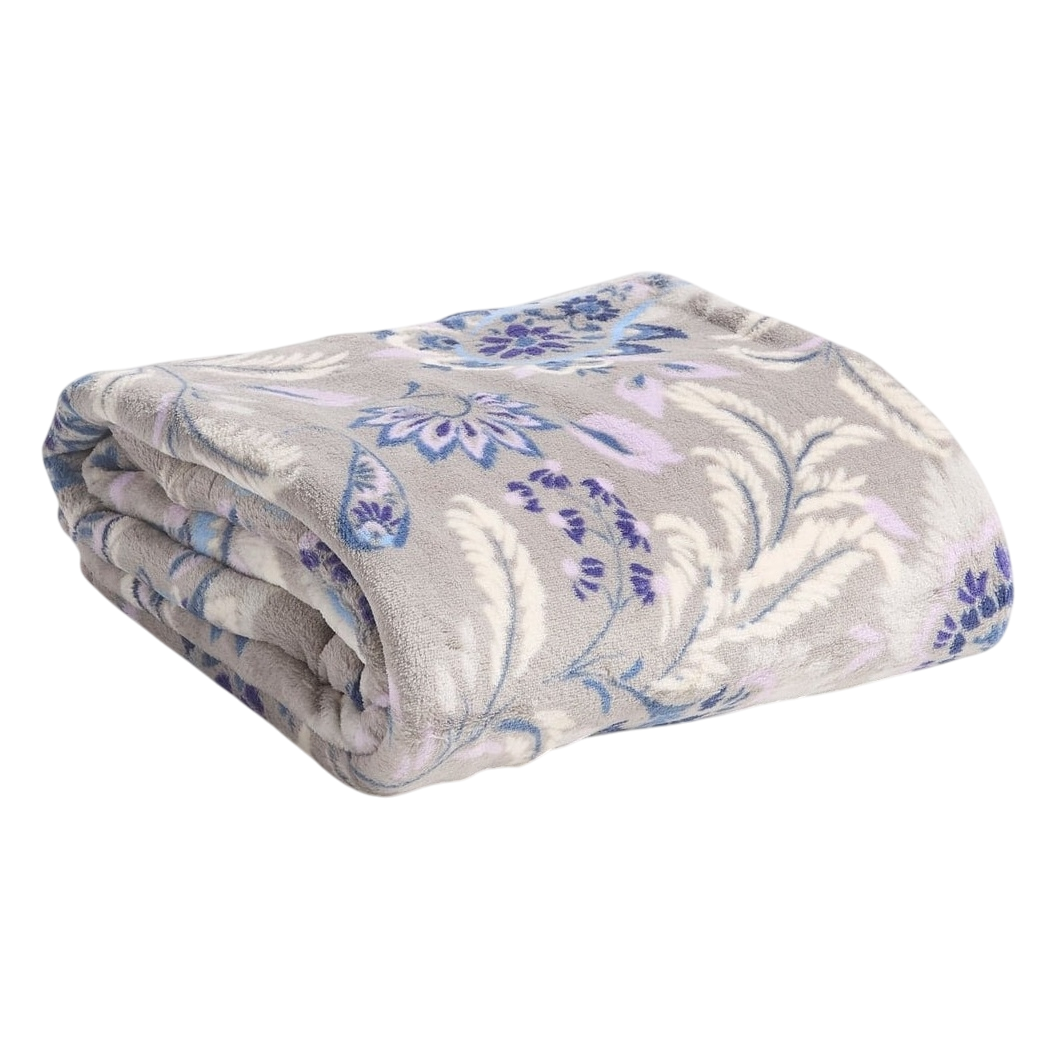 A folded, plush blanket with a floral pattern in shades of blue, purple, and white on a gray background.