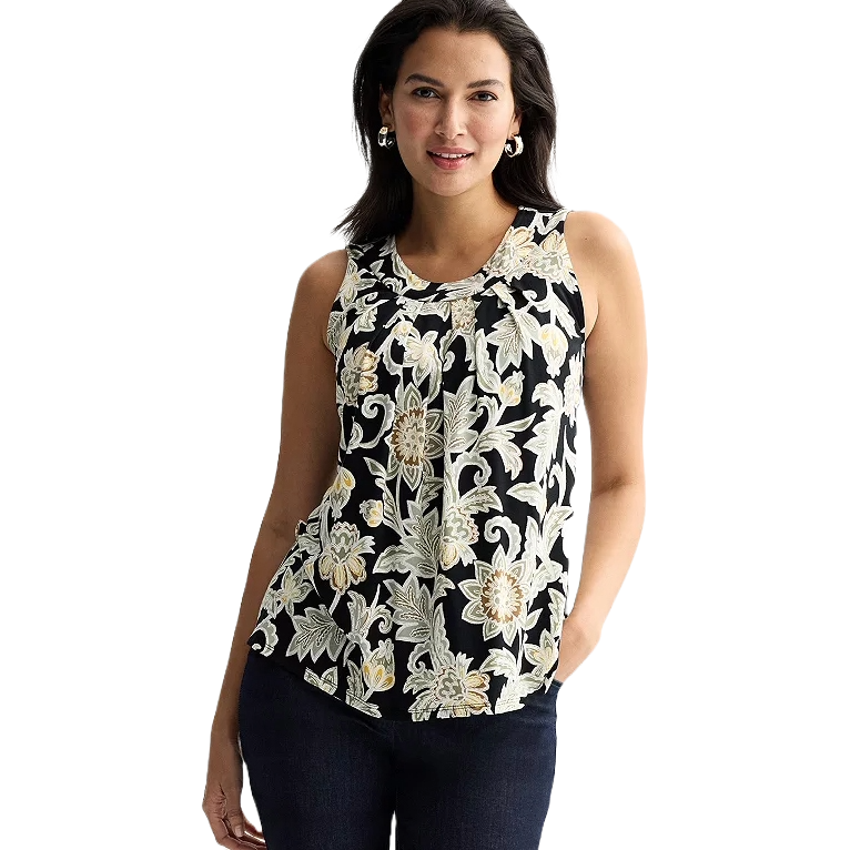 Sleeveless floral blouse with a black background, featuring beige and white floral patterns. The model is wearing dark jeans and hoop earrings.