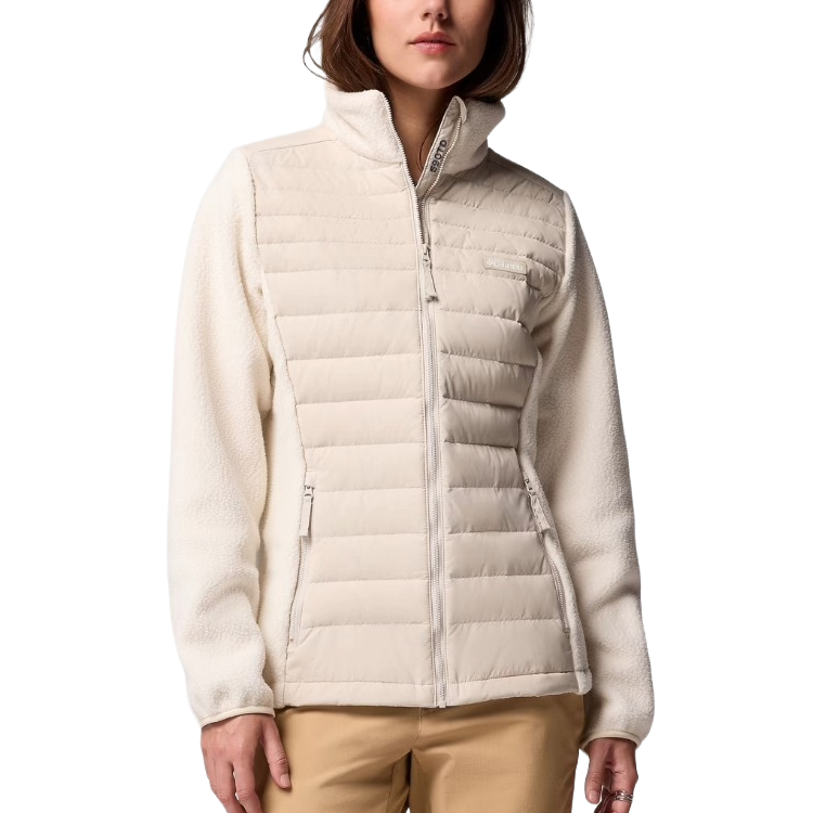 A woman is wearing a light cream Columbia jacket with quilted insulation on the front and fleece sleeves.