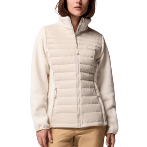 A woman is wearing a light cream Columbia jacket with quilted insulation on the front and fleece sleeves.
