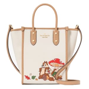A Kate Spade New York handbag featuring a playful design with two cartoon chipmunks and a red mushroom, accented with brown handles and a crossbody strap.