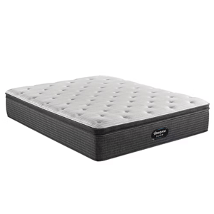 A mattress with a tufted white top and a dark gray patterned base labeled \“Beautyrest Silver.\“